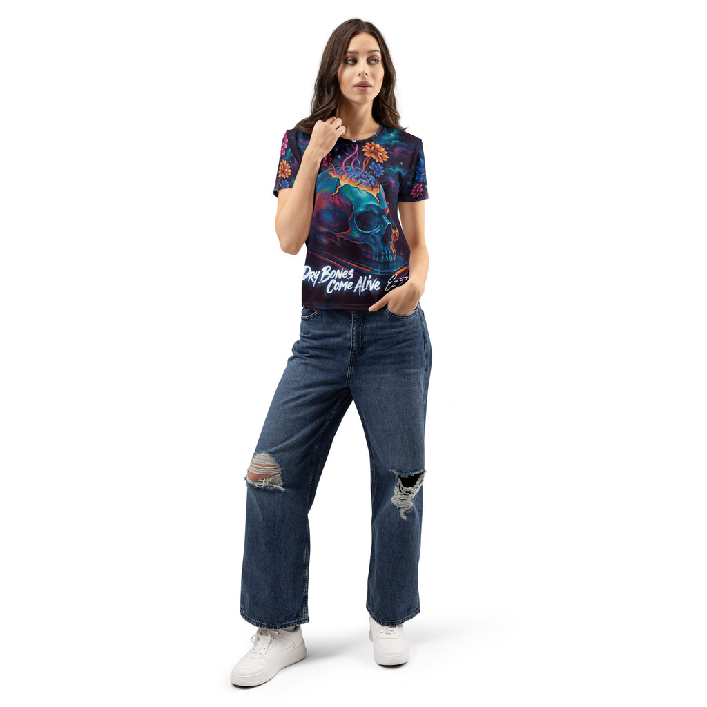 Woman wearing a patterned black and white shirt with skull and flowers with "Dry Bones Come Alive" text at bottom from Ezekiel 37. Woman wearing blue jeans on a white background