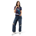 Woman wearing a patterned black and white shirt with skull and flowers with "Dry Bones Come Alive" text at bottom from Ezekiel 37. Woman wearing blue jeans on a white background