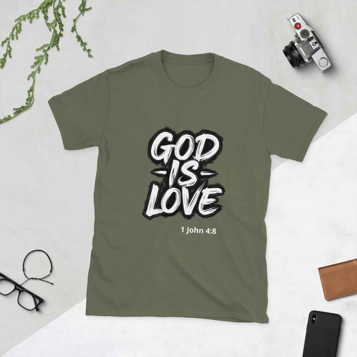 Green Christian t-shirt with motivational design saying "God is Love 1 John 4:8" on a light gray background