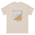 A light beige crewneck Christian t-shirt featuring a graphic of a Bible with one corner peeled back to reveal a textured gold interior, with the text 'OLD' and '2 Cor 5:17' printed below.
